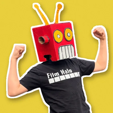 Bennet in his cardboard robot head, flexing