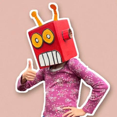 Jules in her cardboard robot head, giving a thumbs up