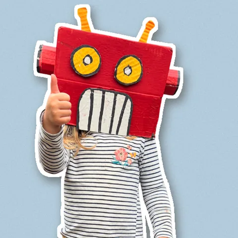 Sylvie in her cardboard robot head, giving a thumbs up